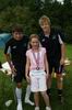 A child who won a contest with two volunteers